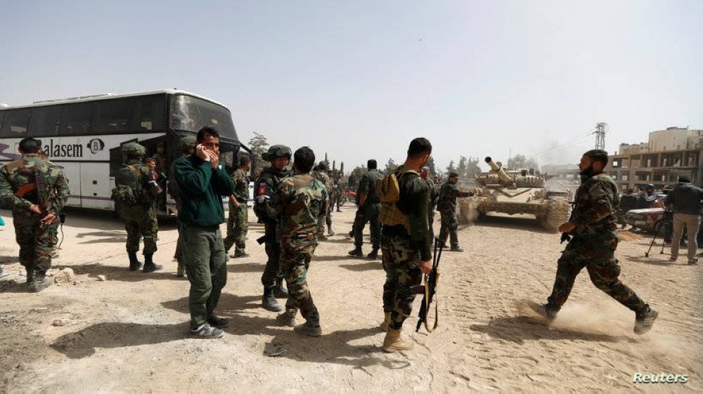 Syrian army soldiers are seen at the entrance of Harasta, in the eastern Damascus suburb of Ghouta, Syria March 22, 2018. REUTERS/Omar Sanadiki