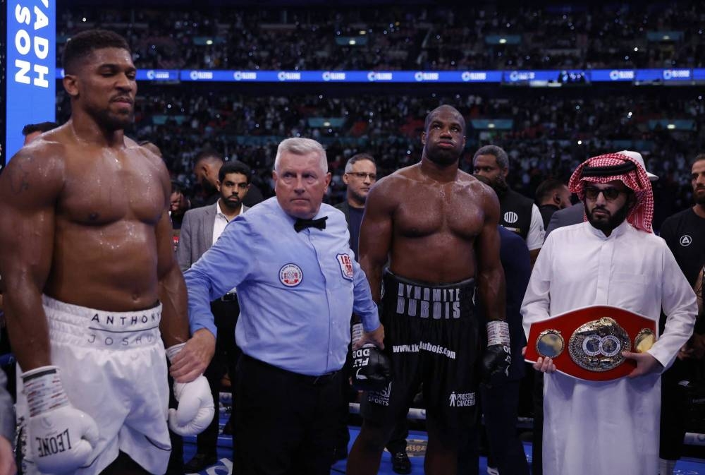 Boxing - Daniel Dubois v Anthony Joshua - IBF World Heavyweight Title - Wembley Stadium, London, Britain - September 21, 2024
Anthony Joshua and Daniel Dubois with chairman of Saudi Arabia's General Entertainment Authority, Turki Al-Sheikh after the fight Action Images via Reuters/Andrew Couldridge